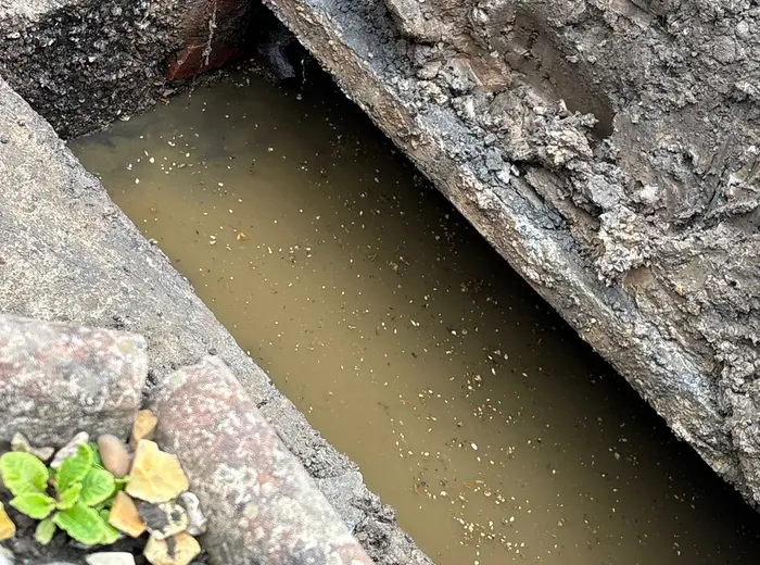 Drainage repair excavation photo showing pipework inspection